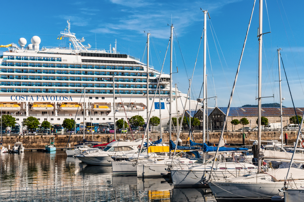 Vigo, Spain - May 20, 2017: Boats moored in the port of Vigo, Galicia, Spain. Cruise ship Costa Favolosa in the background.