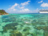 Luxury cruise boat with tropical Seychelles island. Concept of long-distance cruise among the continents.