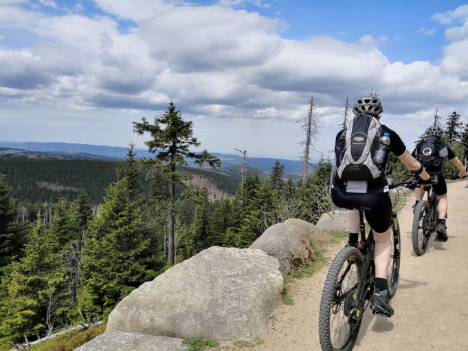TORFHAUS, GERMANY - May 5, 2018: Mountain bikers cycling up the Brocken mountain on hiking trail in Harz mountains