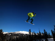 A snowboarder takes flight on Whistler Mountain.