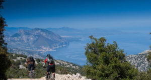 Sardinia on the paths between mountains and sea with the mountain bike, trail to Cala Luna on background the sea