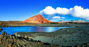 Unique volcanic nature of Lanzarote island with black sands and red mountains