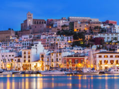Ibiza Dalt Vila downtown at night with light reflections in the water, Ibiza, Spain.