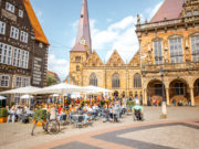 BREMEN, GERMANY - August 09, 2017: View on the Market square with cafes and restaurants full of tourists during the sunny weather in Bremen city, Germany