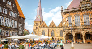 BREMEN, GERMANY - August 09, 2017: View on the Market square with cafes and restaurants full of tourists during the sunny weather in Bremen city, Germany