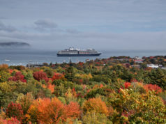 Cloudy morning in Maine overlooking fall foliage and cruise ship departing.