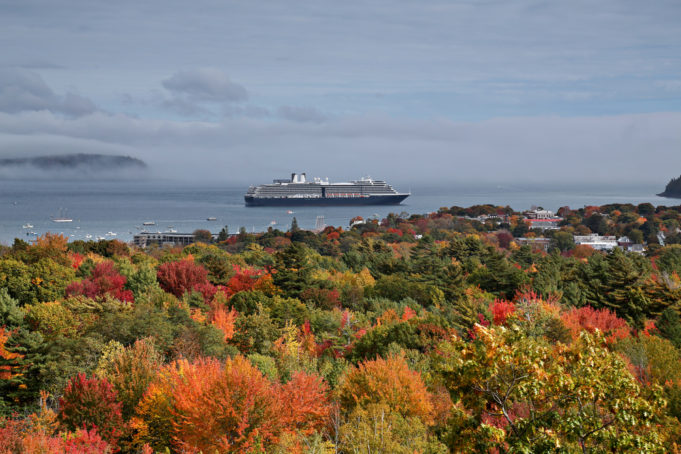 Cloudy morning in Maine overlooking fall foliage and cruise ship departing.