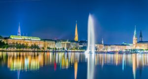 Night view of the old town in Hamburg behind binnenalster lake, Germany