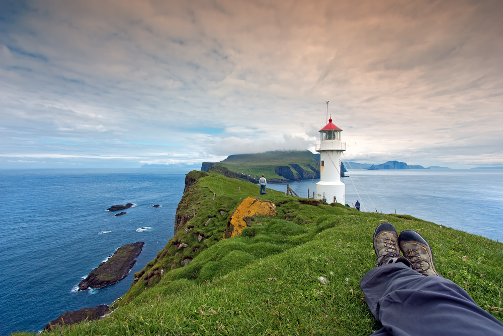 Resting after hiking at Mykines Lighthouse, Faroe Islands